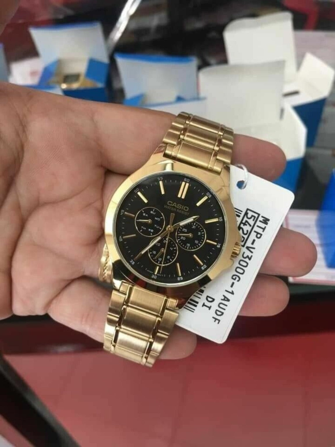 Casio MTP-V300G-1AUDF product hand photo with model tag